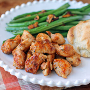Kentucky Chicken Bites on a plate with green beans and a biscuit