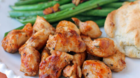 Kentucky Chicken Bites on a plate with green beans and a biscuit