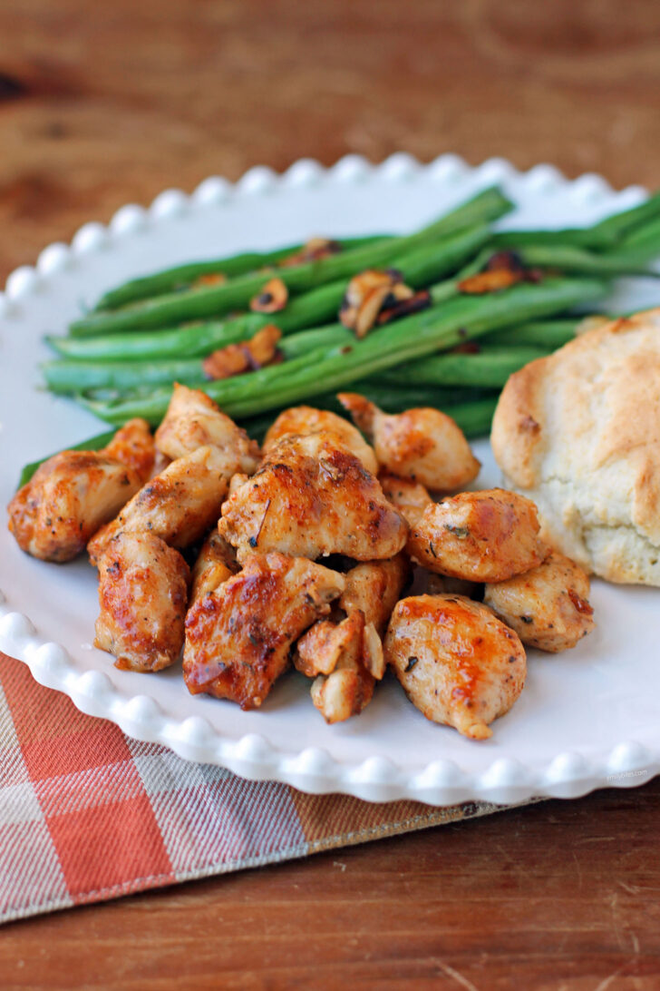 Kentucky Chicken Bites on a plate with green beans and a biscuit