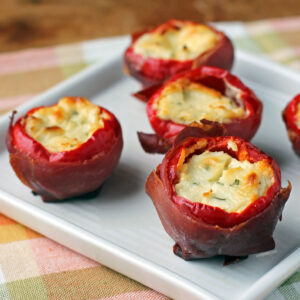 Prosciutto Wrapped Stuffed Cherry Peppers on a plate